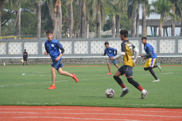 Fravashi International Academy Student Playing Football on Ground